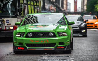 green custom modded mustang with black nissan gtrPicture